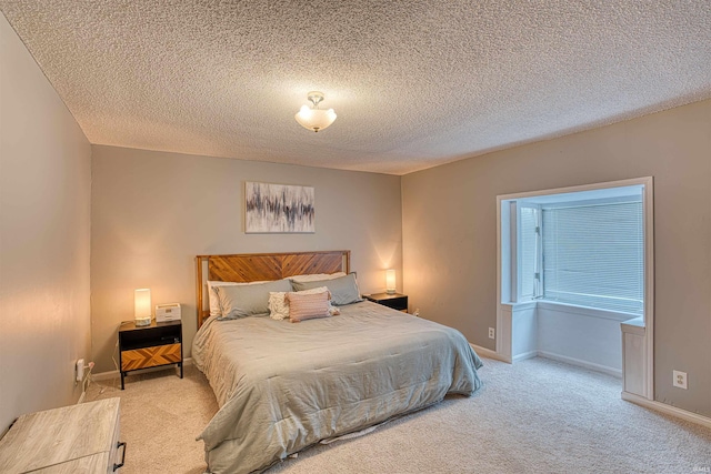 bedroom with light carpet and a textured ceiling