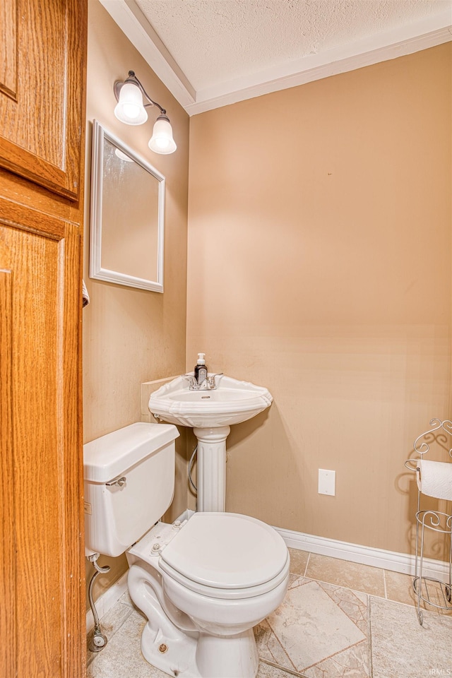 bathroom with toilet, a textured ceiling, and tile patterned flooring