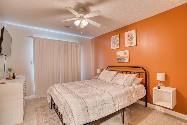 bedroom with light carpet, a textured ceiling, and ceiling fan