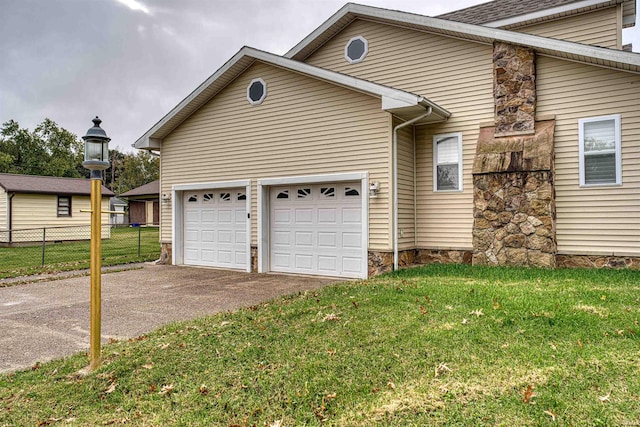 view of property exterior with a garage and a lawn