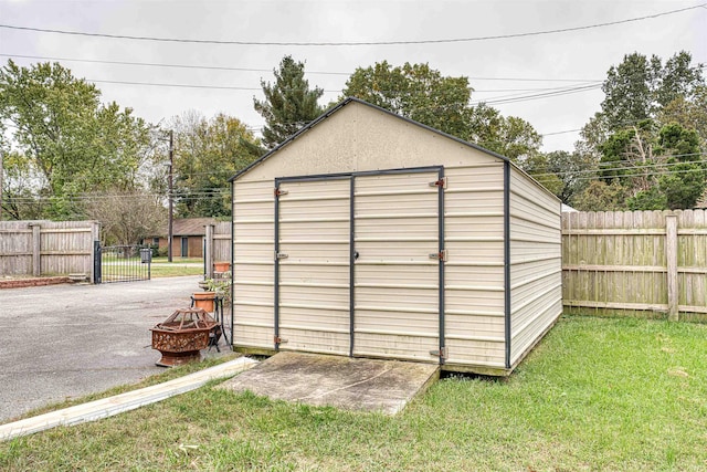 view of outbuilding featuring a lawn