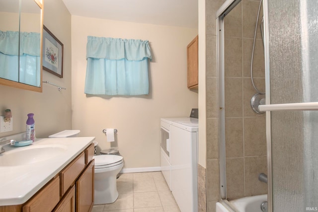 full bathroom with enclosed tub / shower combo, washer and dryer, toilet, vanity, and tile patterned flooring