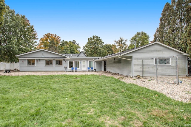 rear view of property featuring a yard