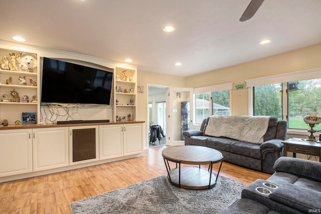 living room featuring ceiling fan and light wood-type flooring