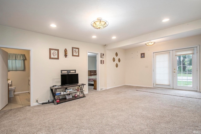 carpeted living room featuring french doors