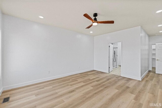 empty room featuring ceiling fan and light hardwood / wood-style flooring