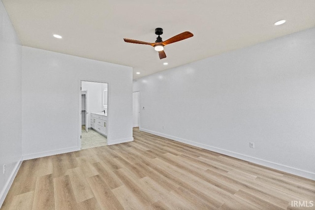 unfurnished bedroom with ensuite bath, light wood-type flooring, and ceiling fan