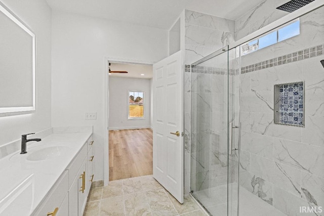 bathroom featuring vanity, hardwood / wood-style floors, and walk in shower