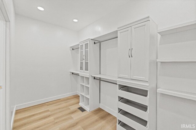 spacious closet with light hardwood / wood-style floors