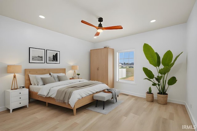 bedroom featuring light hardwood / wood-style flooring and ceiling fan