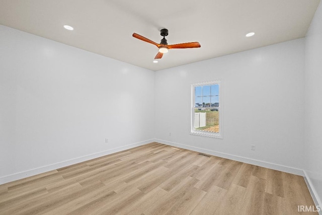 spare room with light hardwood / wood-style floors and ceiling fan