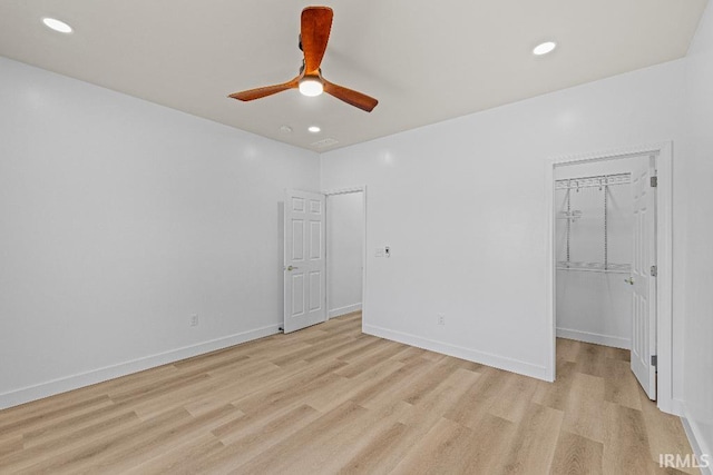 unfurnished room featuring light hardwood / wood-style flooring and ceiling fan