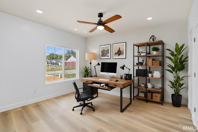 office area with light wood-type flooring and ceiling fan