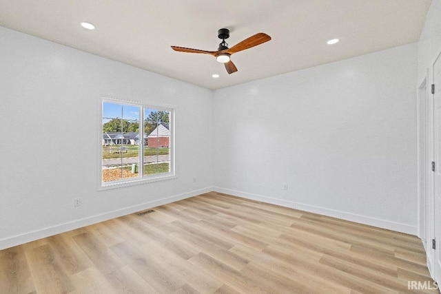 empty room with light wood-type flooring and ceiling fan