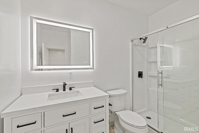 bathroom with vanity, toilet, and an enclosed shower