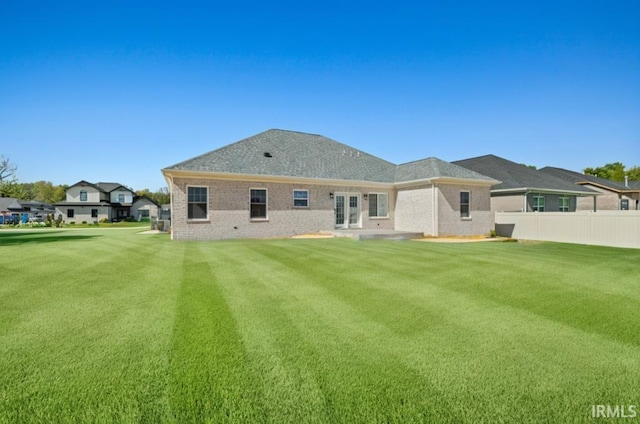 rear view of property with a yard