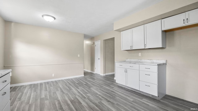 kitchen featuring light hardwood / wood-style floors and white cabinets