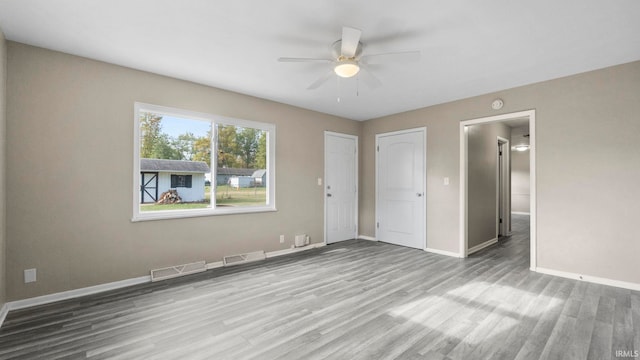 unfurnished bedroom with light hardwood / wood-style floors and ceiling fan