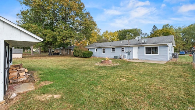 rear view of property with a yard, cooling unit, and a patio