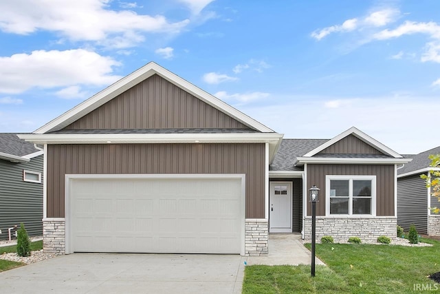 1916 Newbury Cir, Goshen, IN 46526 - view of front of property with stone siding, concrete driveway, a garage, and board and batten siding