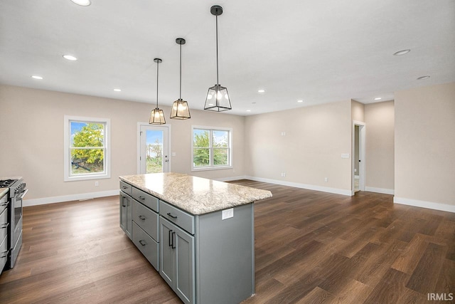 kitchen with a kitchen island, gas range, dark wood-type flooring, hanging light fixtures, and gray cabinets