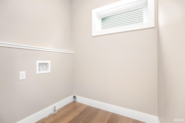 clothes washing area with hookup for a washing machine, gas dryer hookup, and light hardwood / wood-style floors