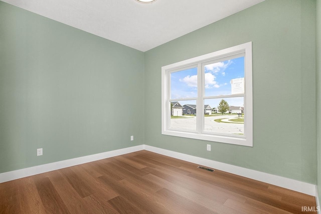 spare room with hardwood / wood-style flooring