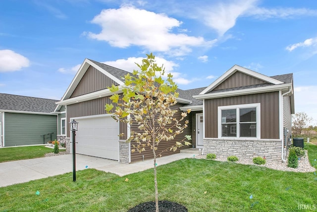 craftsman house with a front yard, central AC, and a garage