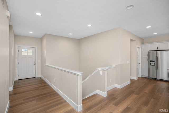 corridor with dark hardwood / wood-style flooring