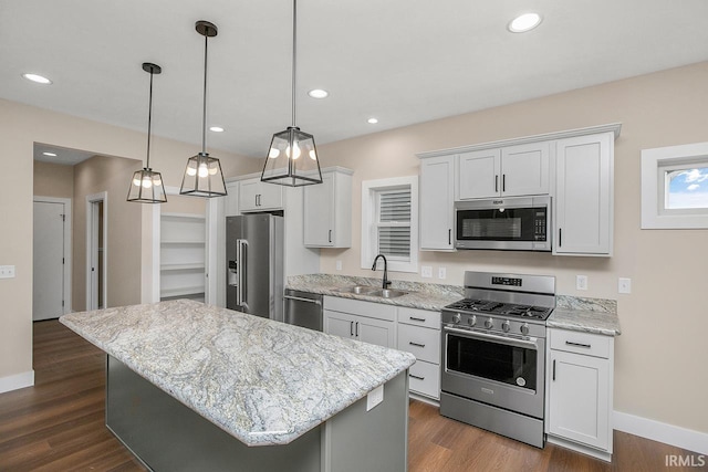 1916 Newbury Cir, Goshen, IN 46526 - kitchen with appliances with stainless steel finishes, a kitchen island, dark wood finished floors, white cabinetry, and light stone counters