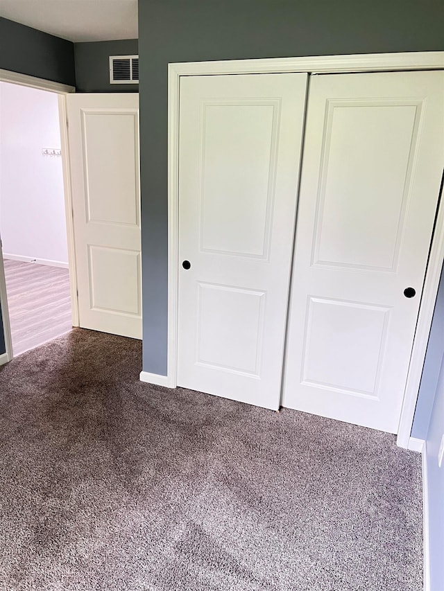 unfurnished bedroom featuring a closet and carpet floors