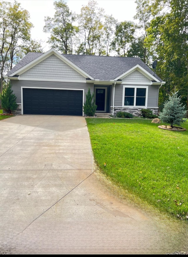 view of front of home featuring a front yard and a garage