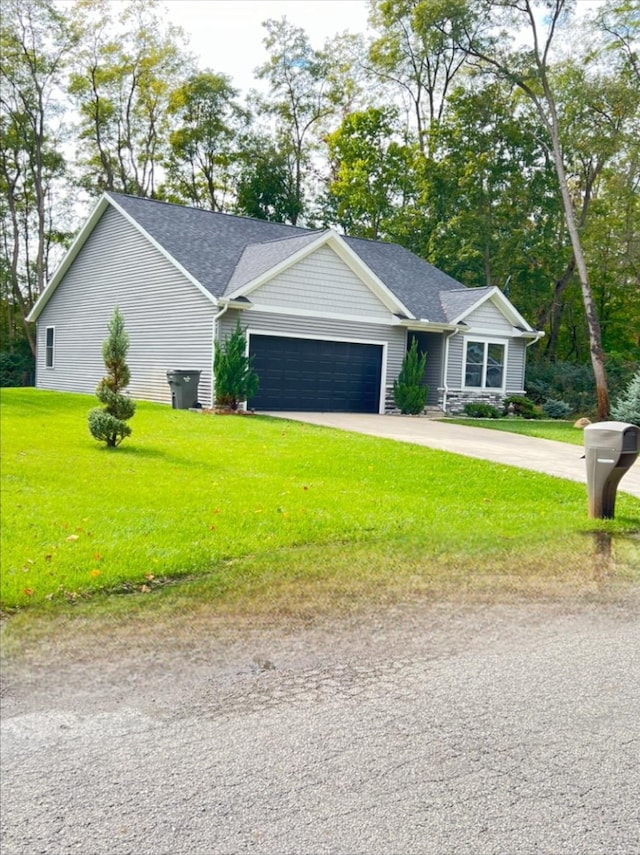 ranch-style home featuring a front yard and a garage