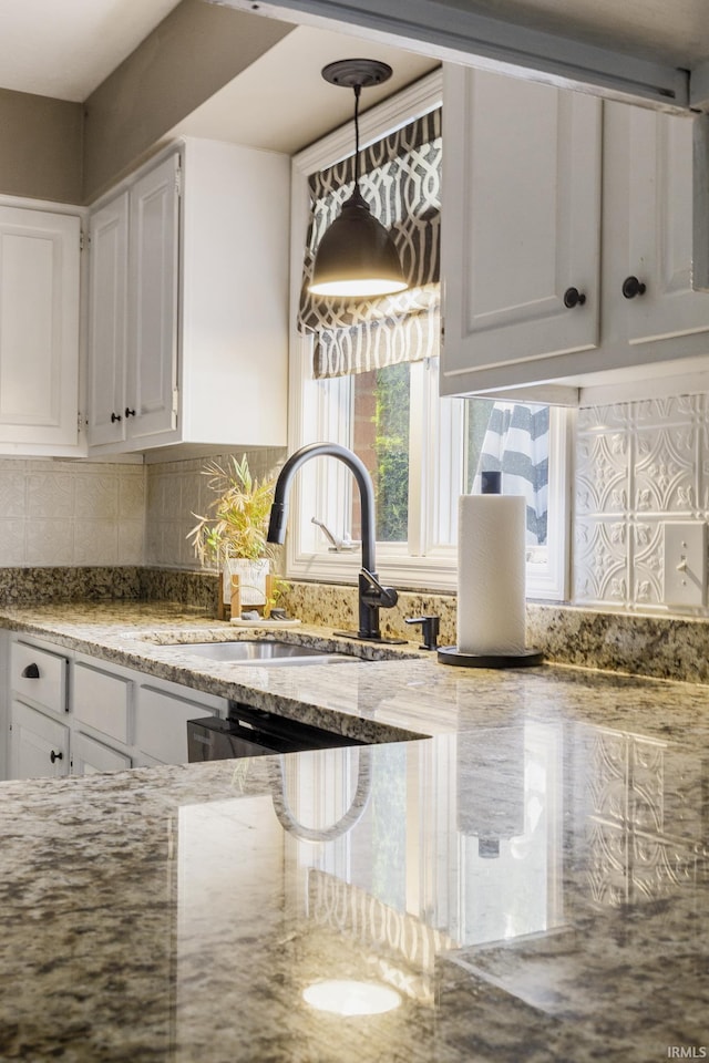 2324 W 56th Hwy, Scottsburg, IN 47170 - kitchen with decorative backsplash, light stone countertops, white cabinetry, a sink, and decorative light fixtures