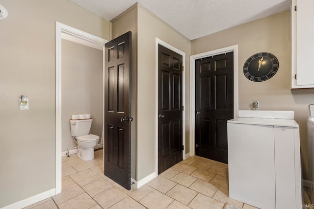 bathroom with toilet and a textured ceiling