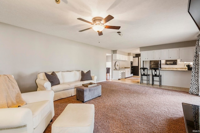 living room featuring light colored carpet and ceiling fan