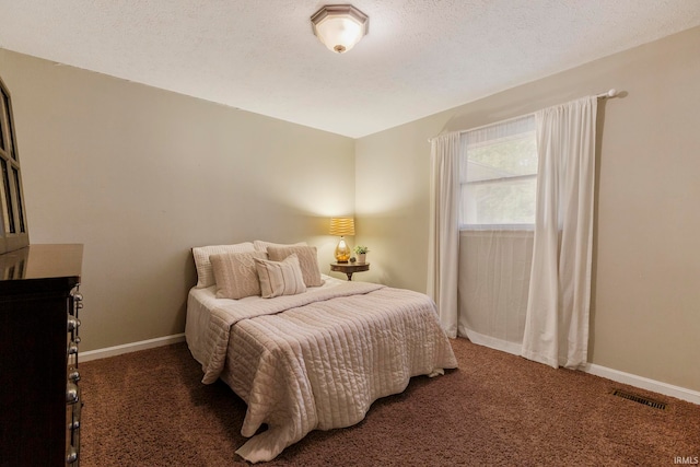 carpeted bedroom featuring a textured ceiling