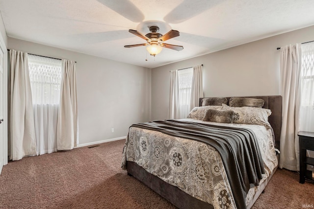 carpeted bedroom with a textured ceiling and ceiling fan