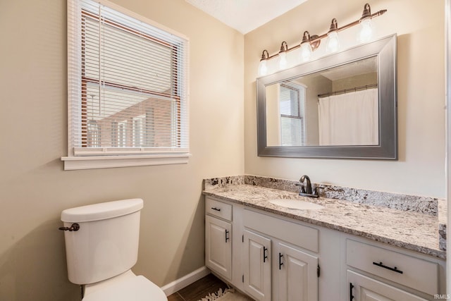 bathroom featuring vanity and toilet