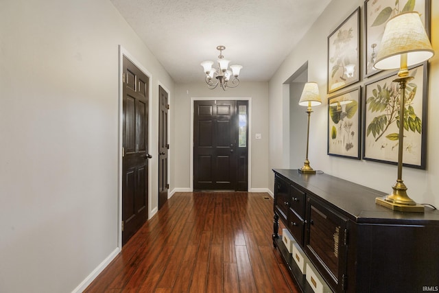 2324 W 56th Hwy, Scottsburg, IN 47170 - foyer entrance with baseboards, dark wood finished floors, and a chandelier