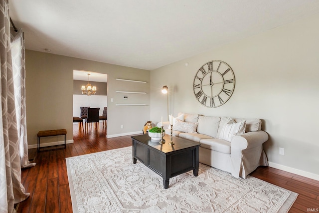 living room with hardwood / wood-style flooring and an inviting chandelier