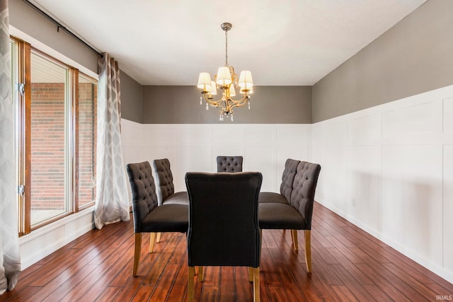 dining room featuring an inviting chandelier, dark hardwood / wood-style floors, and plenty of natural light