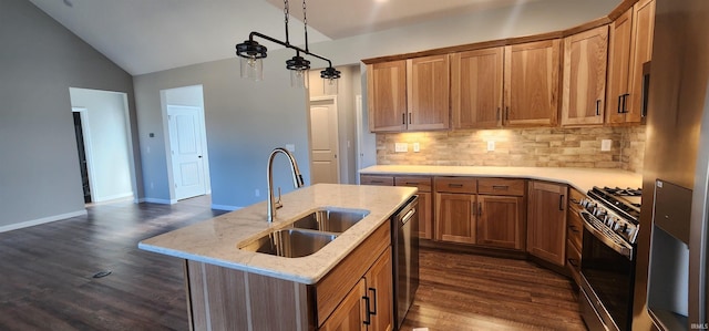 kitchen featuring lofted ceiling, sink, tasteful backsplash, appliances with stainless steel finishes, and an island with sink