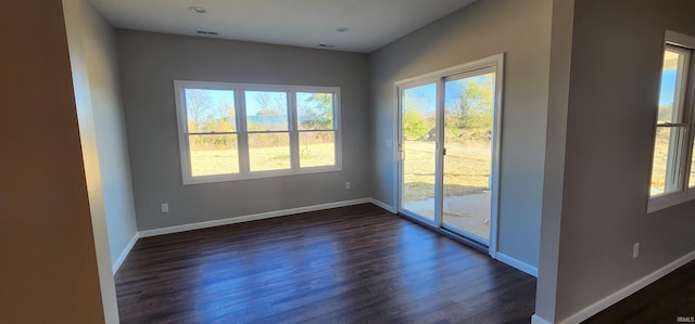 empty room with dark hardwood / wood-style flooring