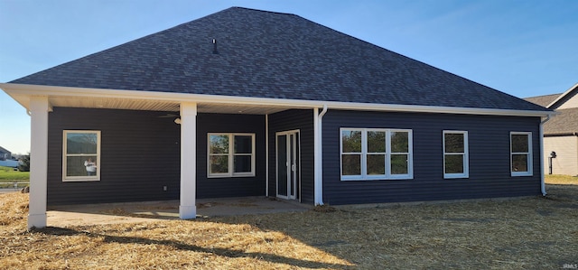 back of house with a yard and a patio