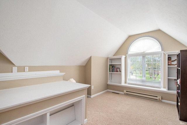 interior space featuring a baseboard radiator, vaulted ceiling, and light colored carpet