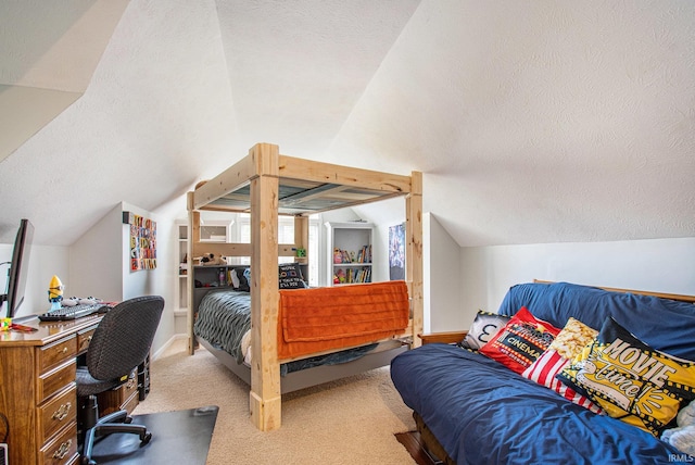 bedroom with vaulted ceiling, light carpet, and a textured ceiling