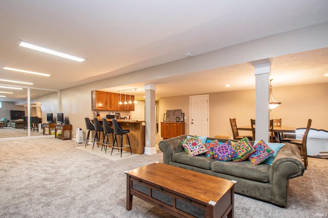 carpeted living room featuring bar area