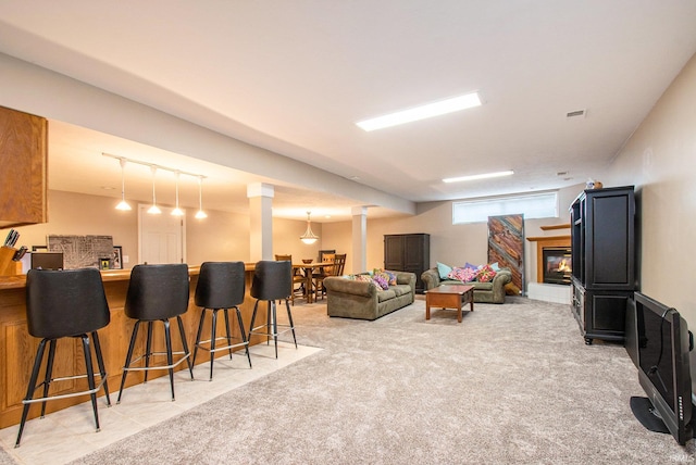 living room featuring bar area and carpet flooring