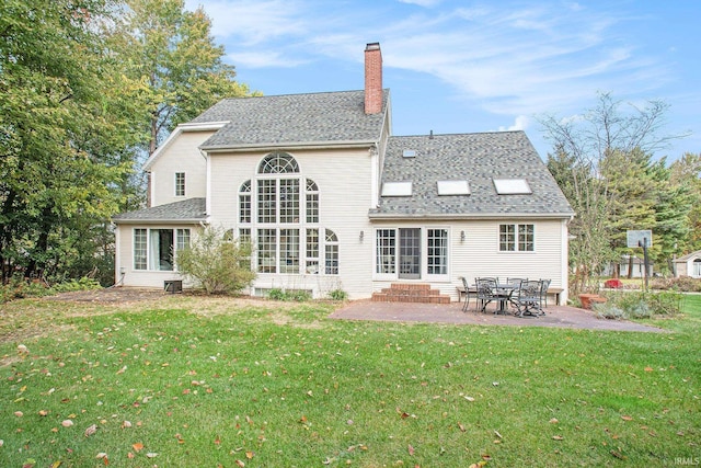 rear view of property with a patio and a lawn